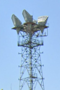 Photograph of a radio tower with large horn shaped receivers at the top